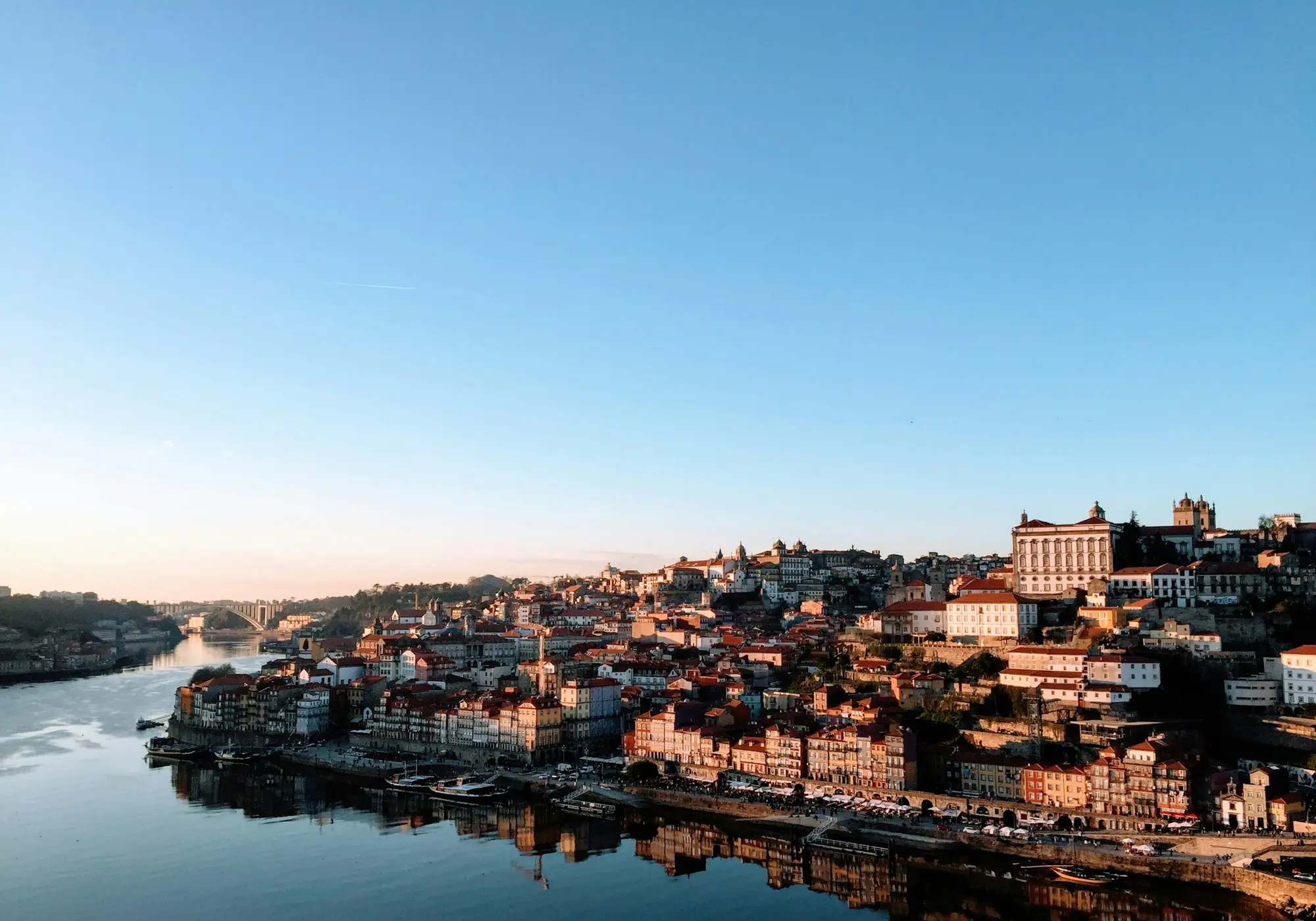 The historic Porto riverfront along the Douro river at golden hour, Portugal